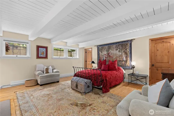 a bedroom with furniture and wooden floor