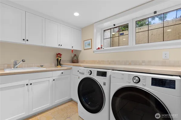 a utility room with sink dryer and washer