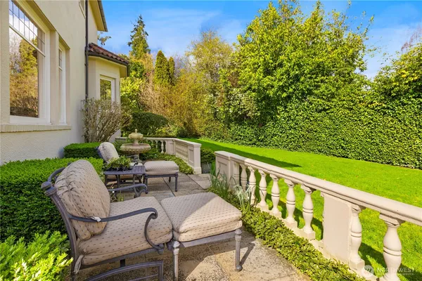 a balcony with table and chairs