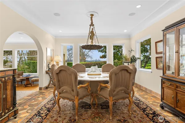 a dining room with furniture a chandelier and wooden floor