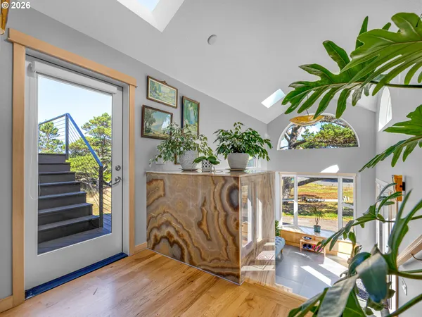 a view of an entryway with wooden floor