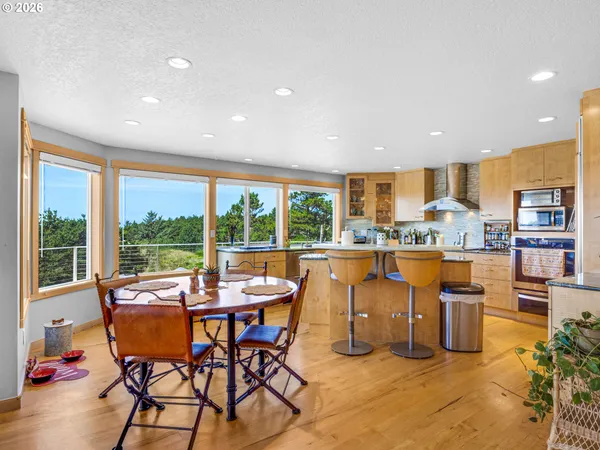 a very nice looking dining room with kitchen island furniture a large window and a sink