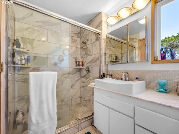 a bathroom with a shower and a sink