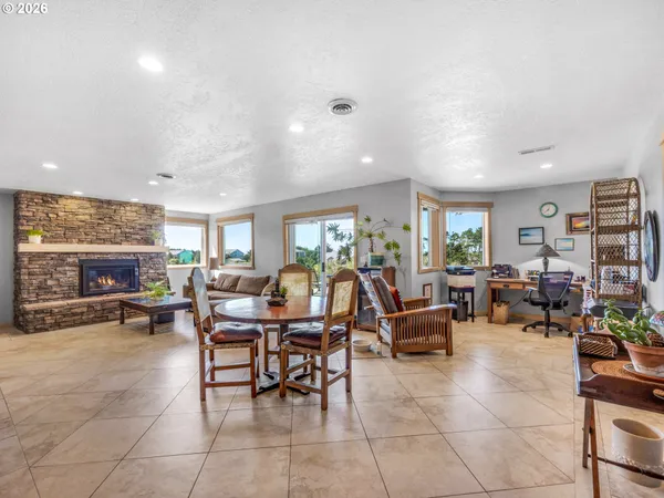 a living room with furniture large window and a fireplace