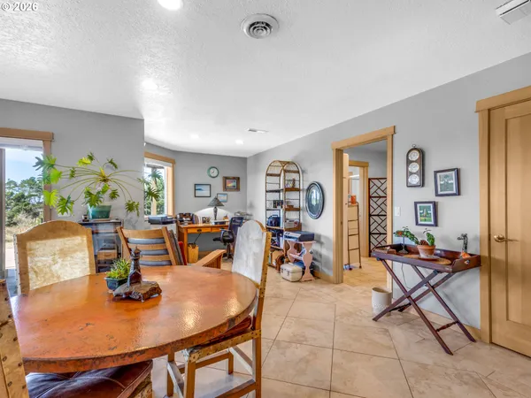 a view of a dining room with furniture and a potted plant