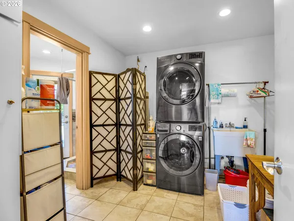 a utility room with sink dryer and washer