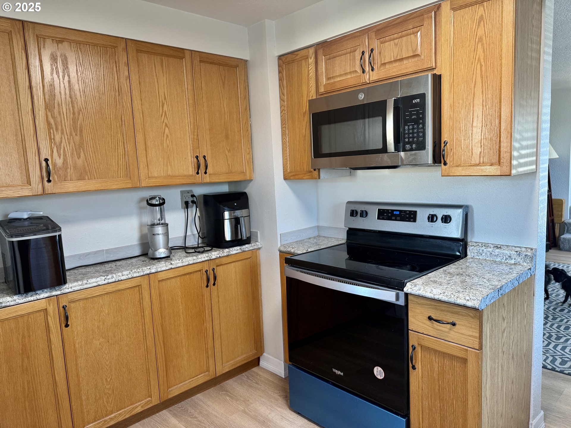 345 38th Street Springfield, OR 97478 - Photo 9 of 29 a kitchen with stainless steel appliances granite countertop a stove microwave and sink