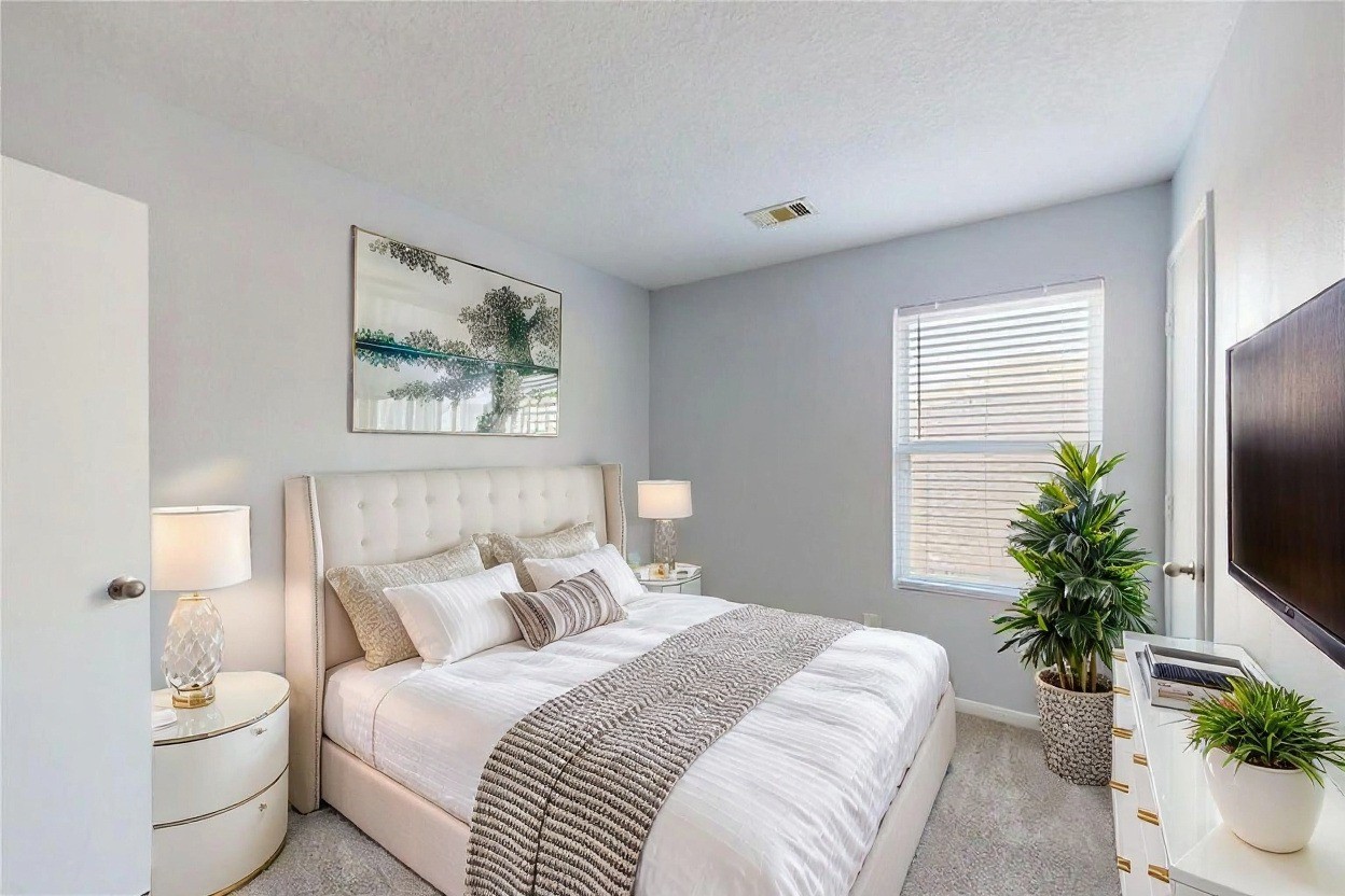 9877 Lace Flower Way Conroe, TX 77385 - Photo 31 of 43 a bedroom with a large bed and a potted plant