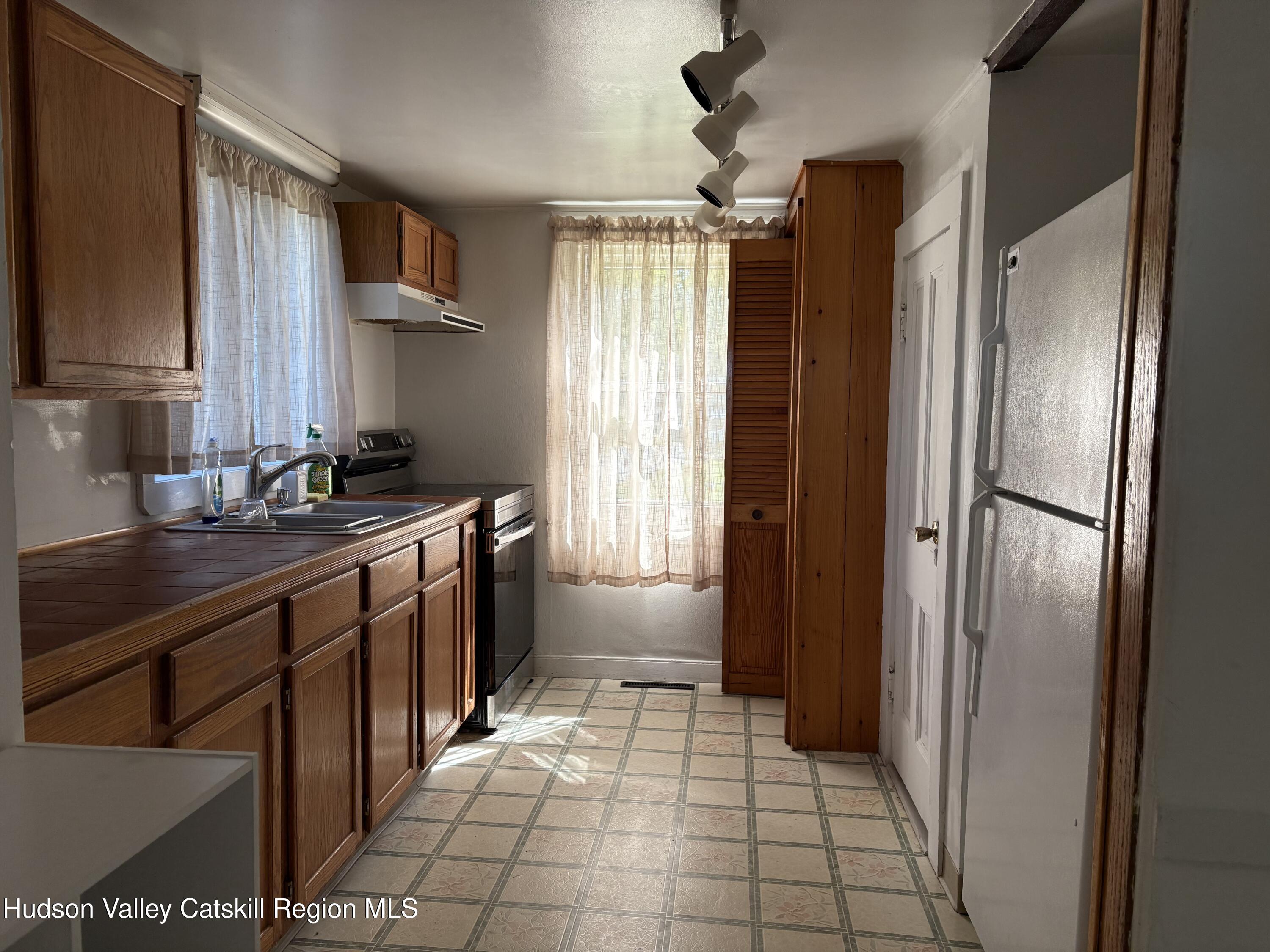 42 Maple Avenue, Unit 2 Highland, NY 12528 - Photo 3 of 11 a kitchen with stainless steel appliances a refrigerator and a sink
