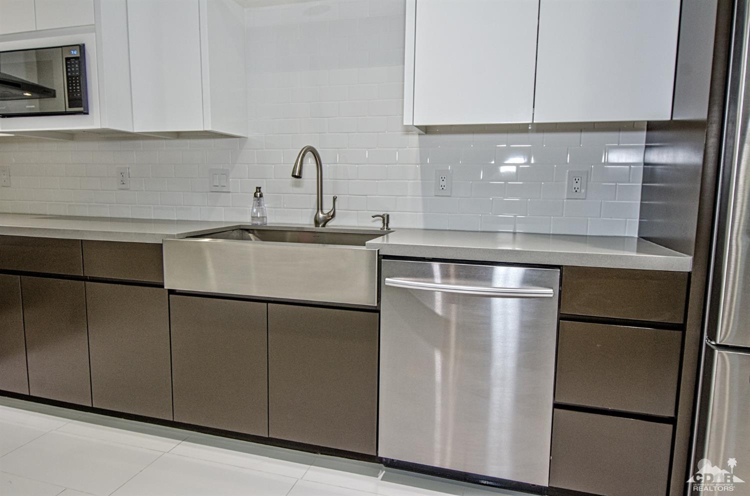 125 Lakeshore Drive Rancho Mirage, CA 92270 - Photo 19 of 79 a kitchen with a refrigerator and a sink