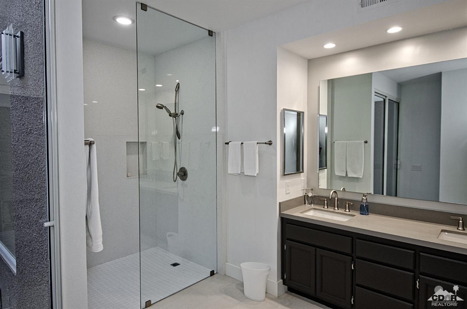 125 Lakeshore Drive Rancho Mirage, CA 92270 - Photo 23 of 79 a bathroom with a shower sink and mirror