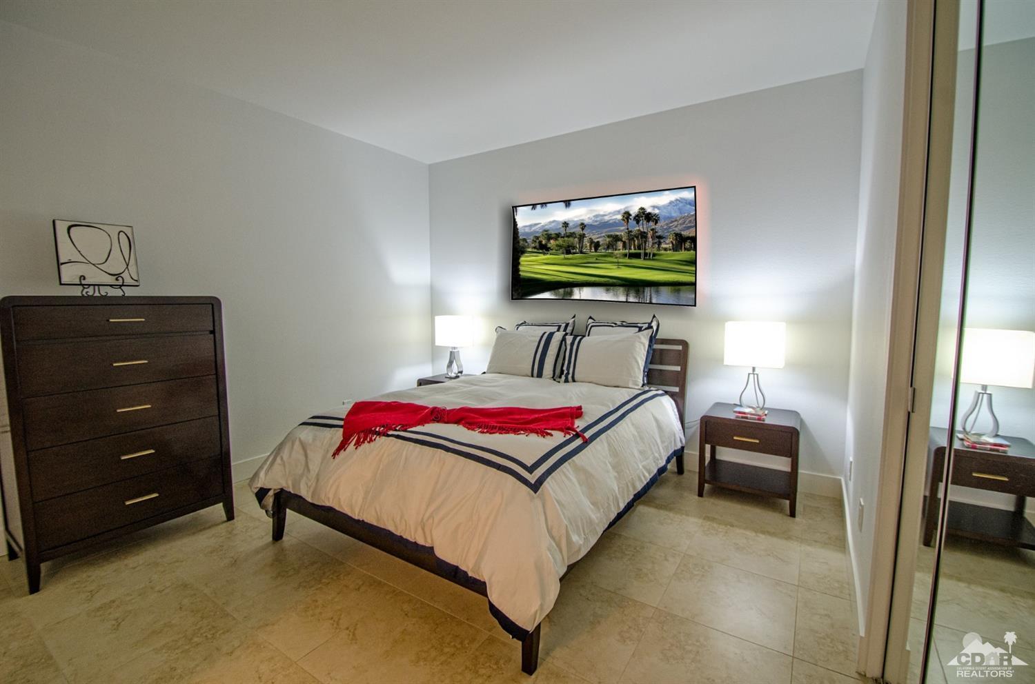 125 Lakeshore Drive Rancho Mirage, CA 92270 - Photo 34 of 79 a bedroom with a bed and a flat screen tv