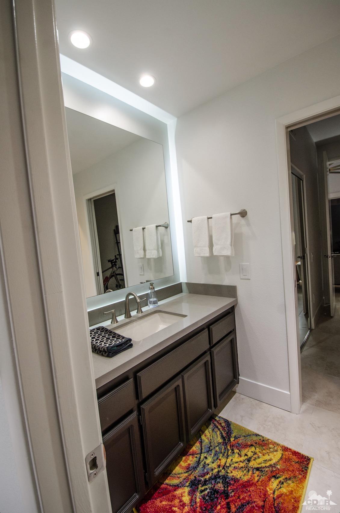 125 Lakeshore Drive Rancho Mirage, CA 92270 - Photo 43 of 79 a bathroom with a sink and a mirror