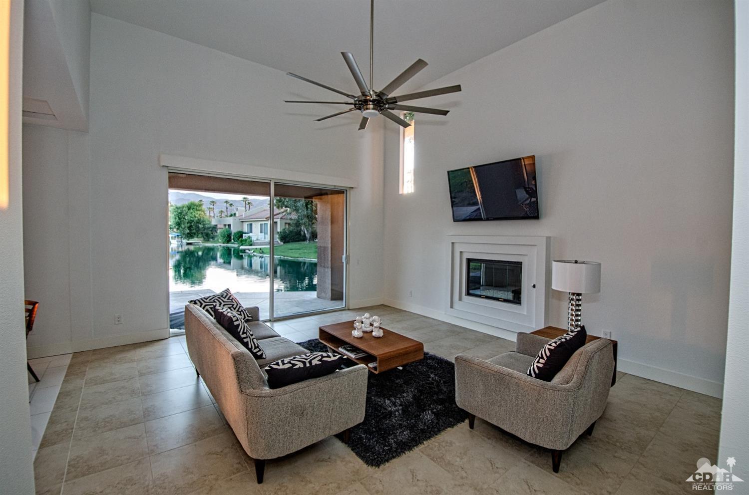 125 Lakeshore Drive Rancho Mirage, CA 92270 - Photo 48 of 79 a living room with furniture a flat screen tv and a fireplace