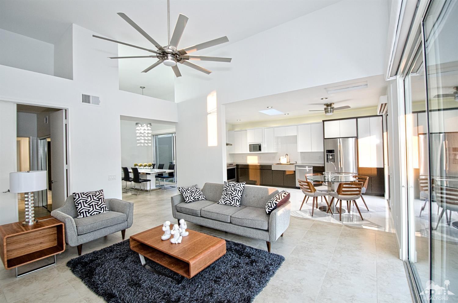 125 Lakeshore Drive Rancho Mirage, CA 92270 - Photo 6 of 79 a living room with furniture a rug and a chandelier