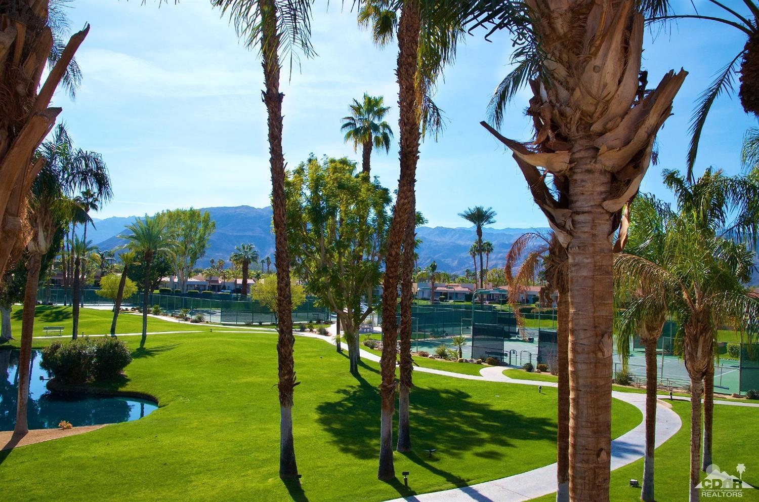 125 Lakeshore Drive Rancho Mirage, CA 92270 - Photo 61 of 79 a backyard of a house with lots of green space and fountain
