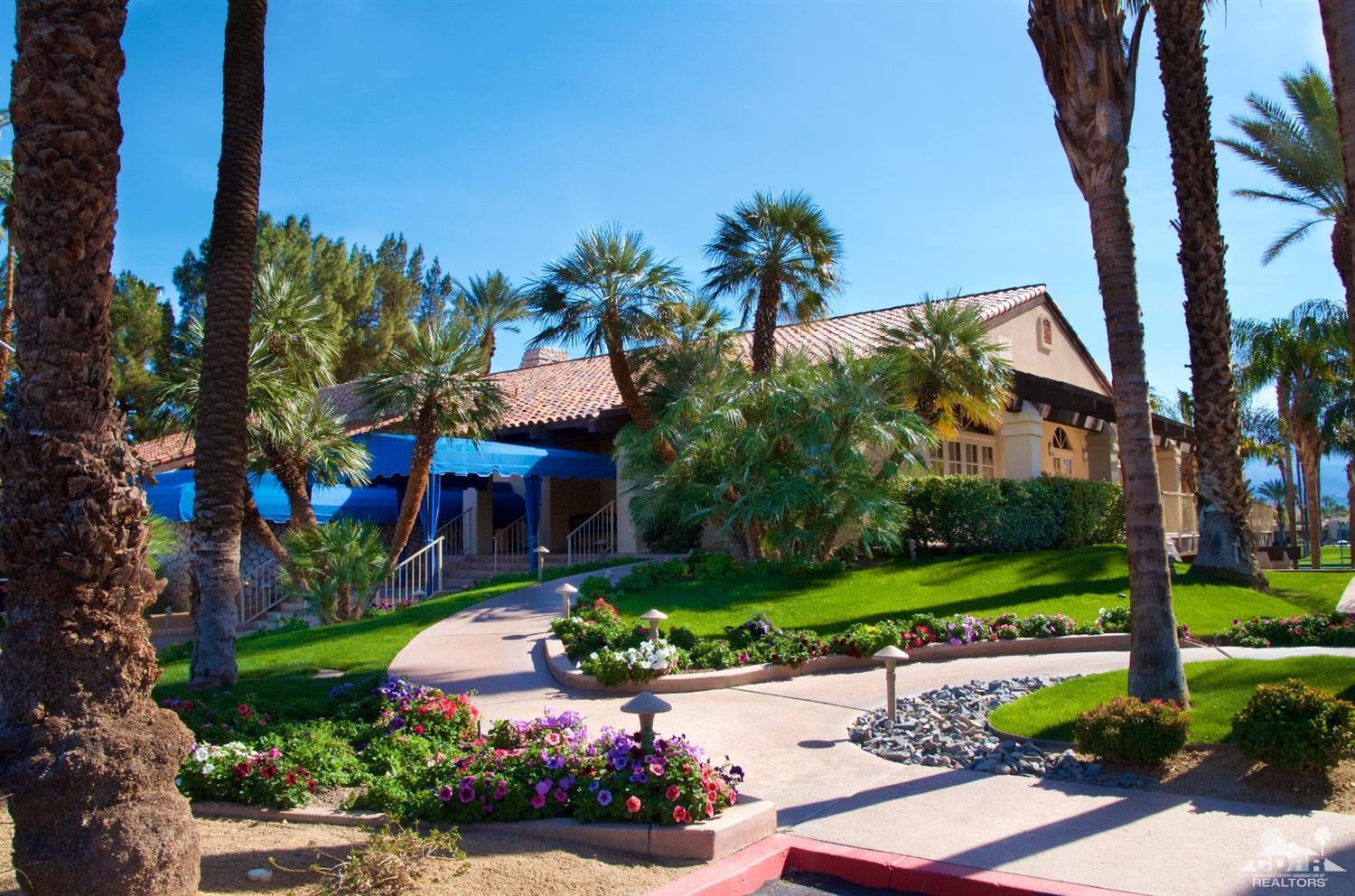 125 Lakeshore Drive Rancho Mirage, CA 92270 - Photo 69 of 79 a front view of a house with a yard and potted plants