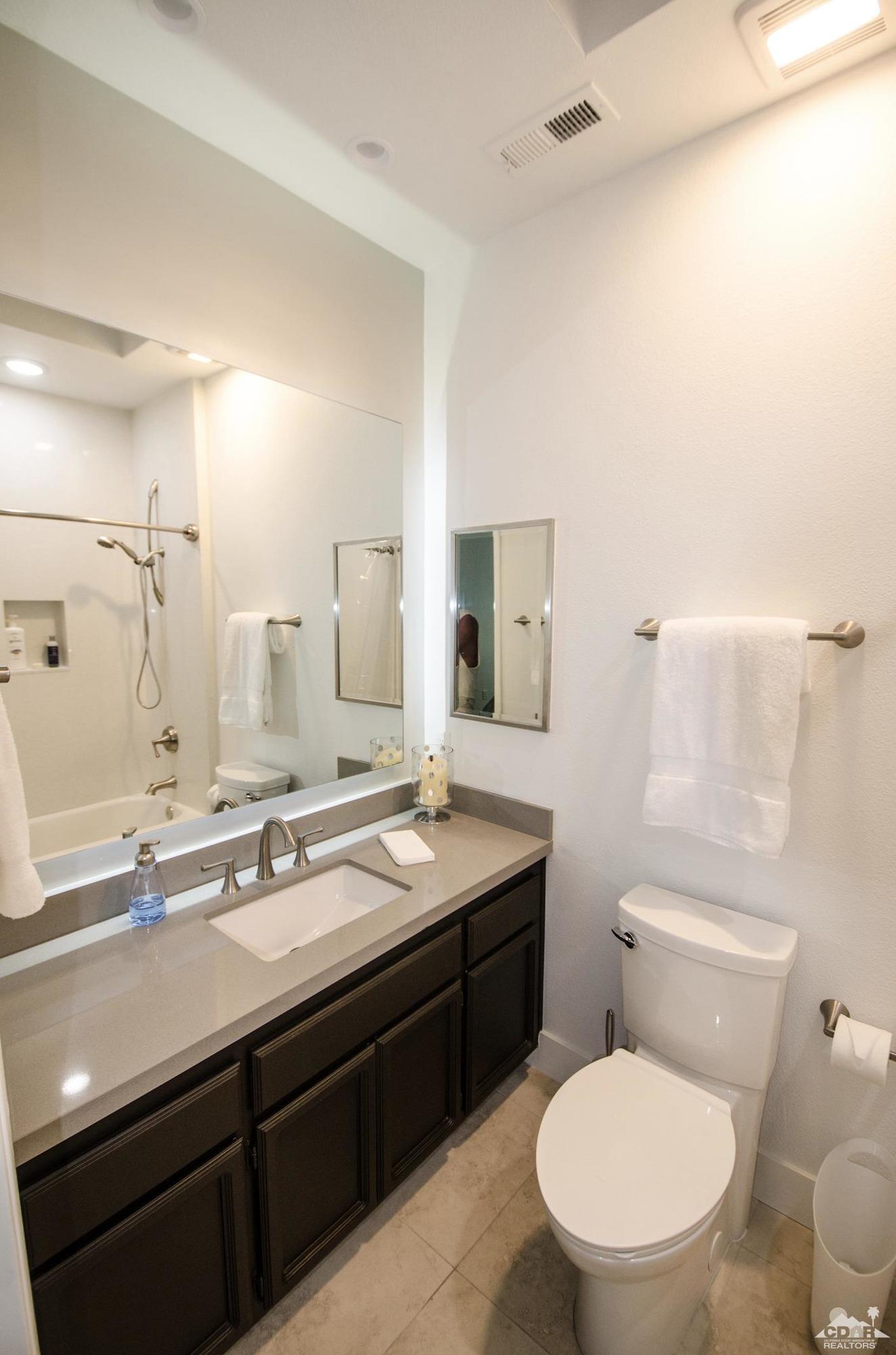 125 Lakeshore Drive Rancho Mirage, CA 92270 - Photo 79 of 79 a bathroom with a granite countertop toilet sink and mirror