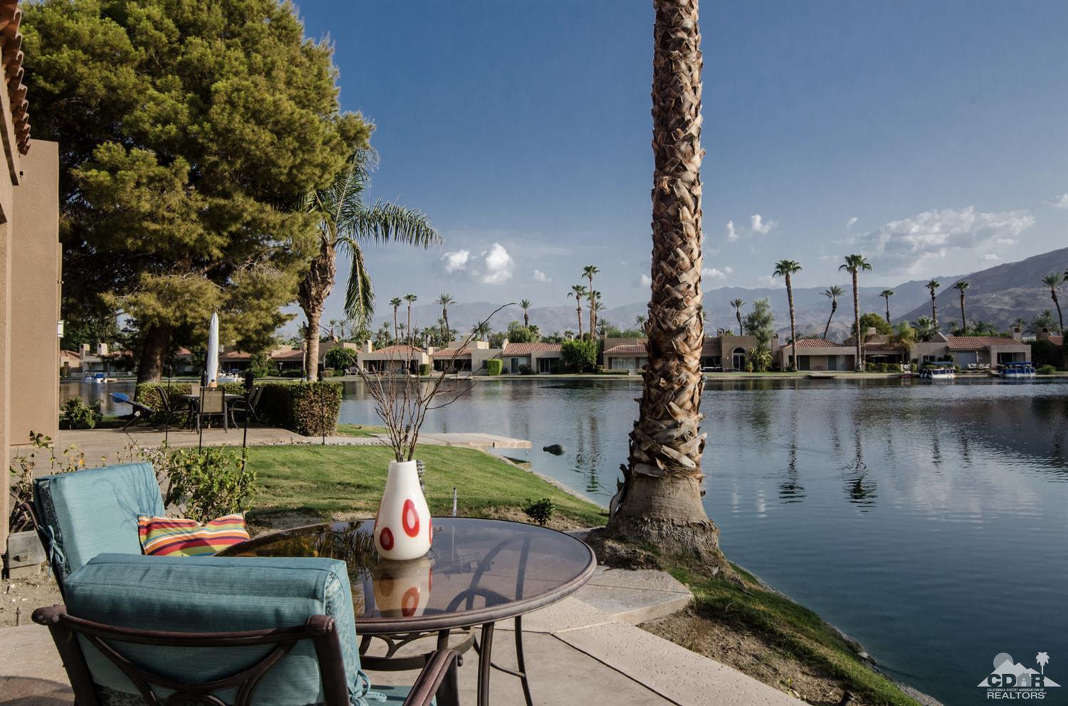 125 Lakeshore Drive Rancho Mirage, CA 92270 - Photo 9 of 79 a lake view with tables and chairs