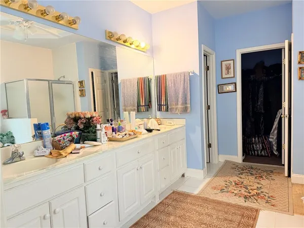 a bathroom with a double vanity sink and mirror
