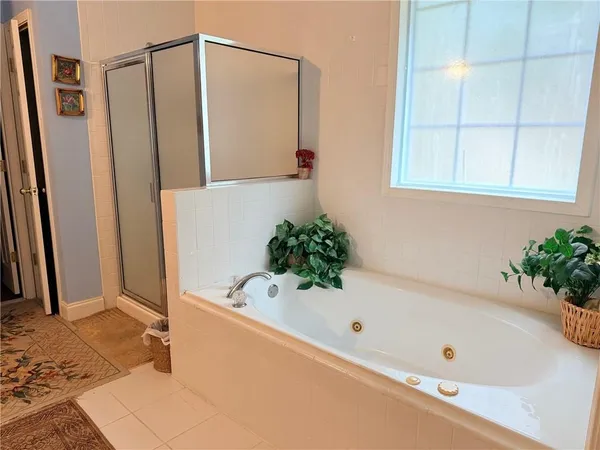 a bathroom with a tub and shower