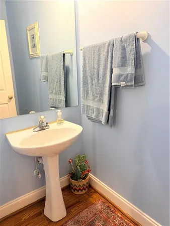 a bathroom with a sink a mirror and tub