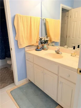 a bathroom with a sink tub vanity and a mirror