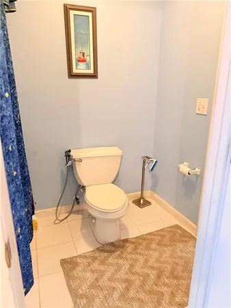 a white toilet sitting next to a bathroom sink