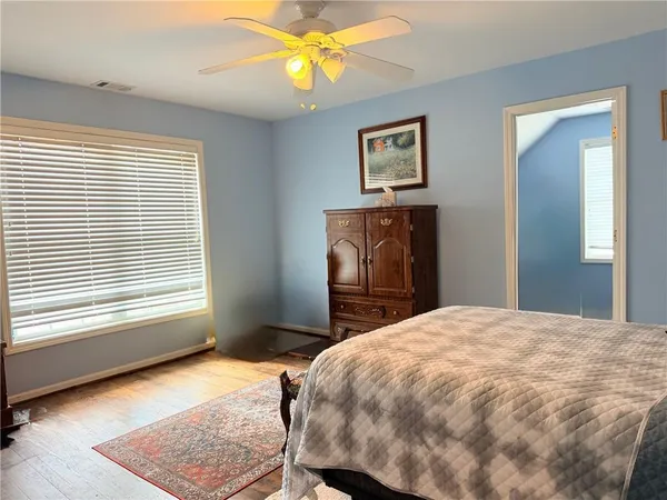 a bedroom with a bed and a window