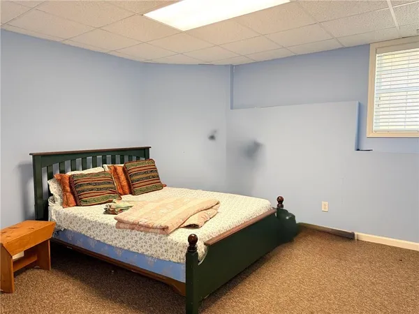 a bed sitting in a bedroom next to a window