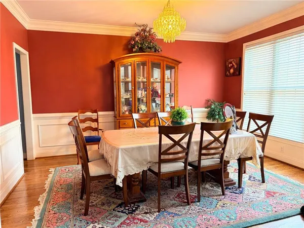 a dining room with furniture and wooden floor
