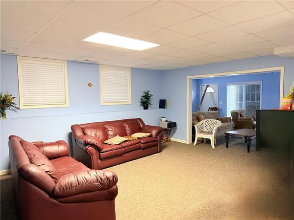 a living room with furniture a couch and a dining table
