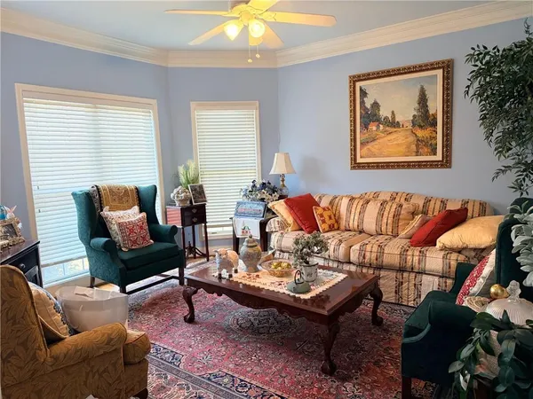 a living room with furniture and a potted plant