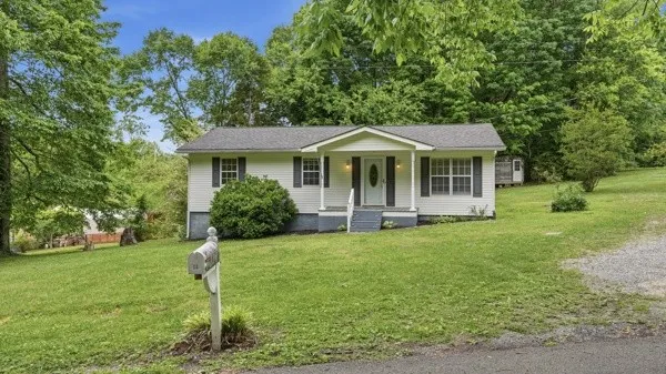 a front view of a house with a yard