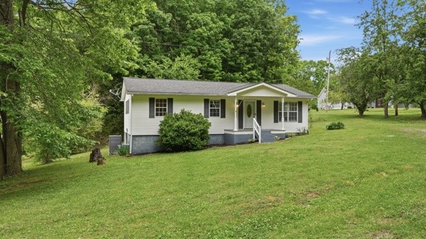 91 Golden Road Lynchburg, TN 37352 - Photo 2 of 24 a front view of a house with a garden