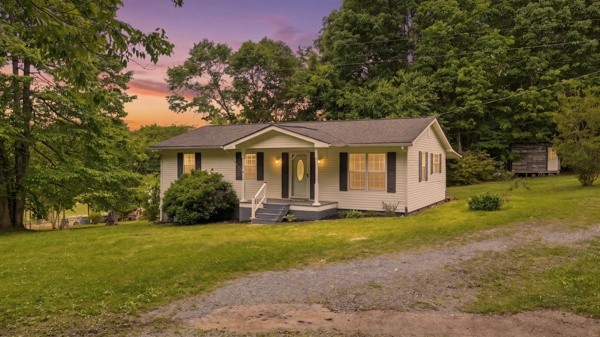 91 Golden Road Lynchburg, TN 37352 - Photo 3 of 24 a front view of a house with a yard