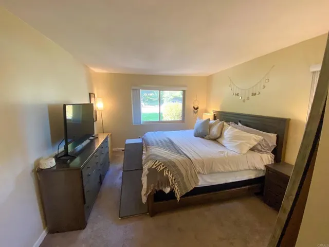 a bedroom with a bed and flat screen tv