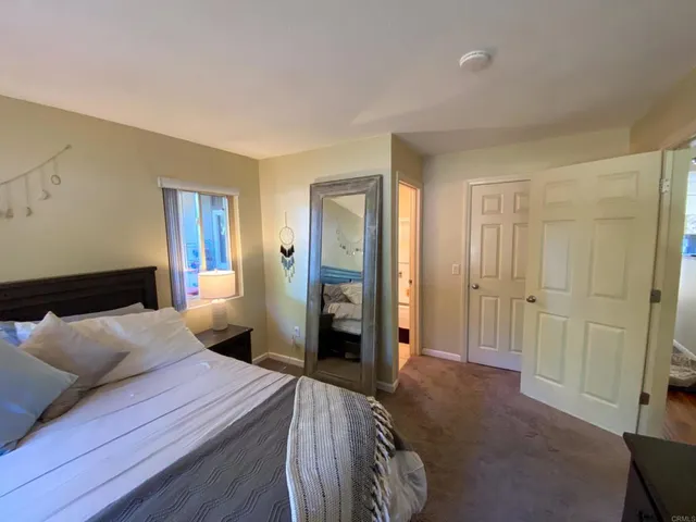 a bedroom with a bed and a walk in closet