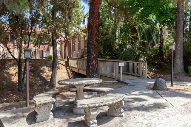a view of a patio with table and chairs and potted plants