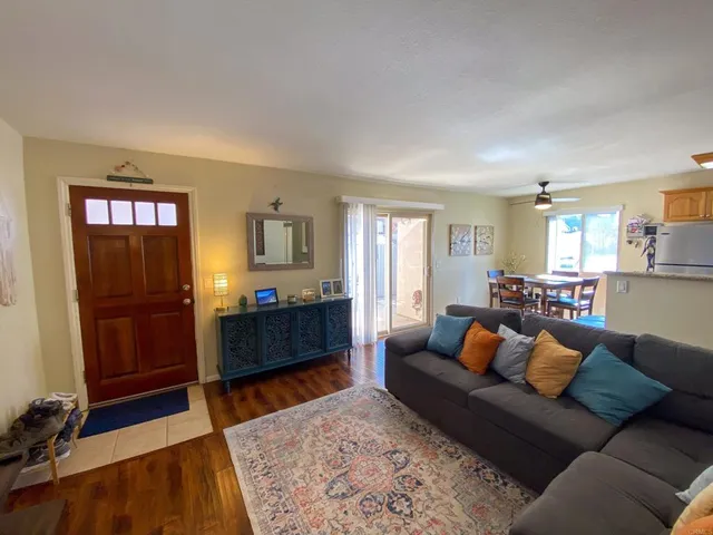 a living room with furniture and a wooden floor