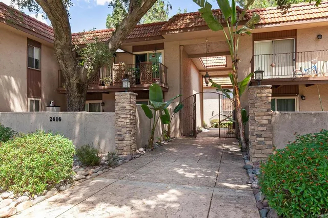 a view of a house with potted plants