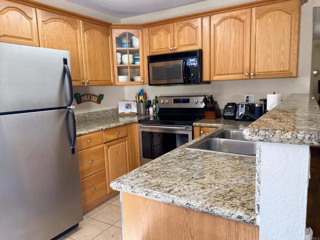 a kitchen with a refrigerator stove and microwave