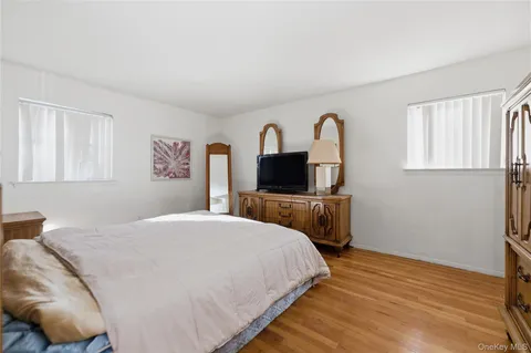 a bedroom with a bed and a television