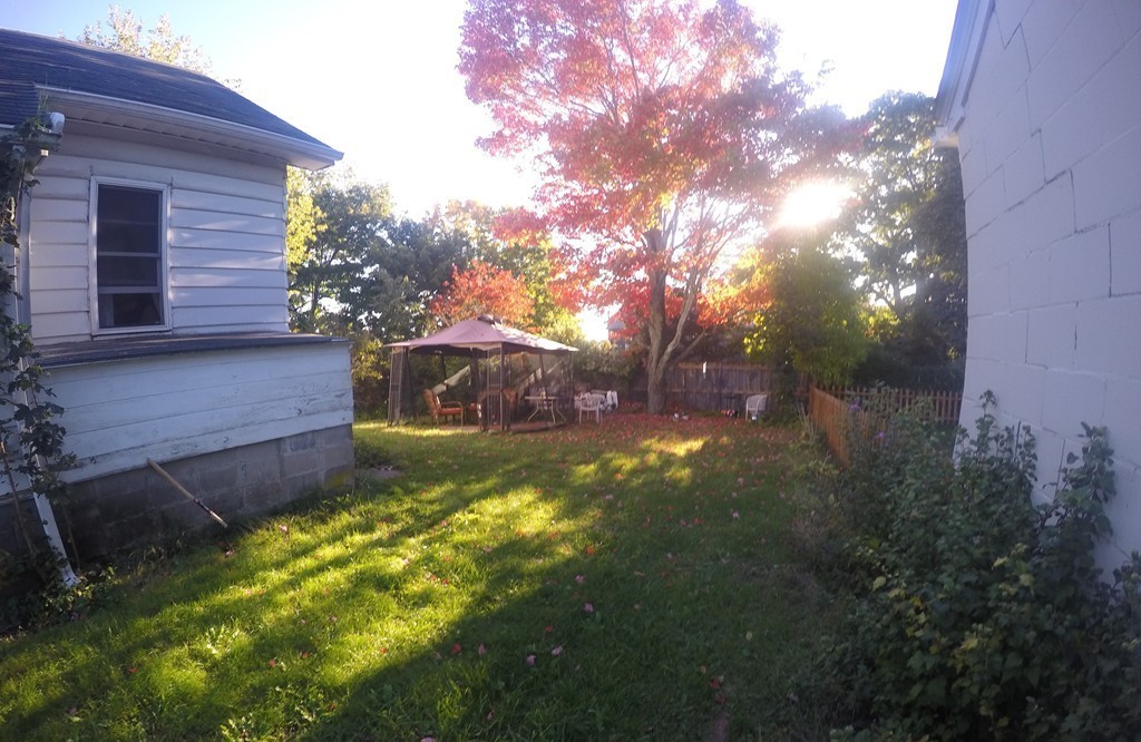 215 Beverly Road Worcester, MA 01605 - Photo 3 of 8 a view of a backyard with large tree