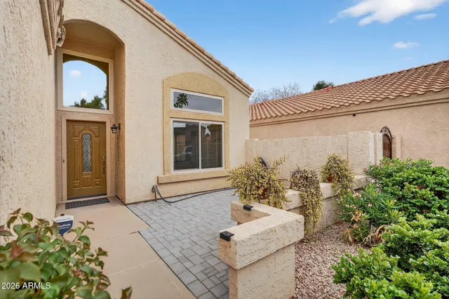 a living room with furniture kitchen view and a chandelier
