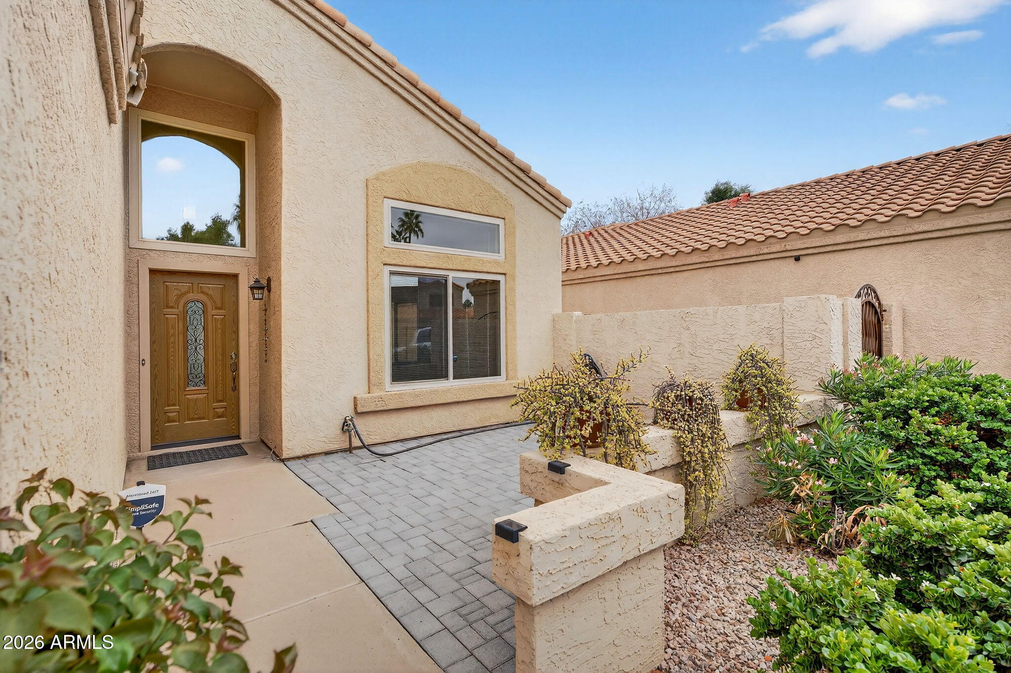 310 East Vaughn Avenue Gilbert, AZ 85234 - Photo 8 of 73 a front view of a house with a garden