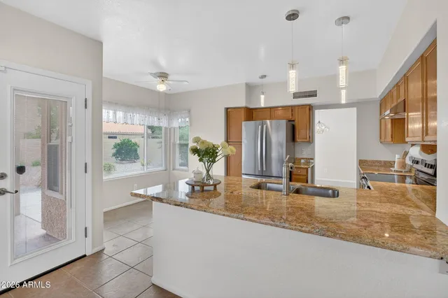 a view of kitchen and refrigerator
