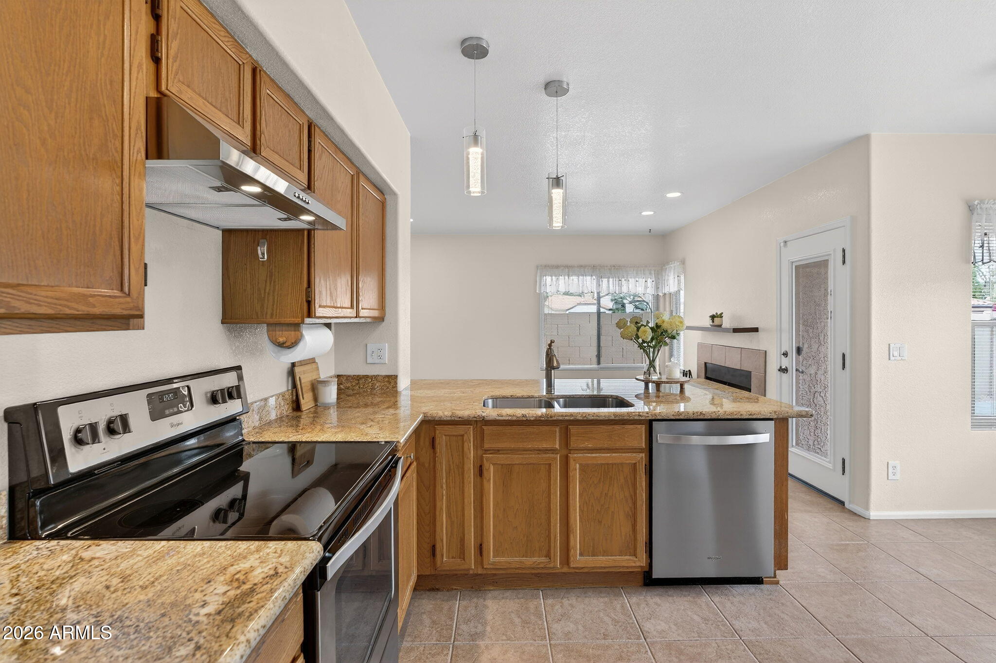 310 East Vaughn Avenue Gilbert, AZ 85234 - Photo 16 of 73 a kitchen with a sink stove and cabinets