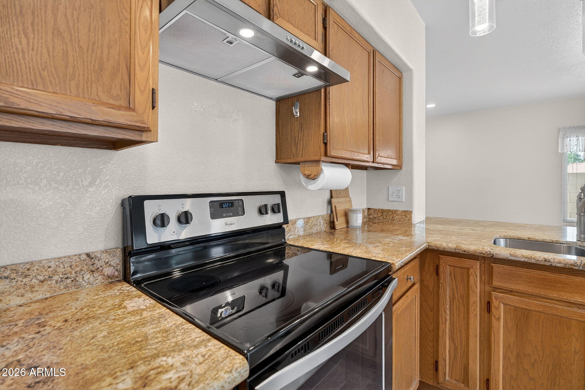 310 East Vaughn Avenue Gilbert, AZ 85234 - Photo 17 of 73 a kitchen with granite countertop a stove and a sink