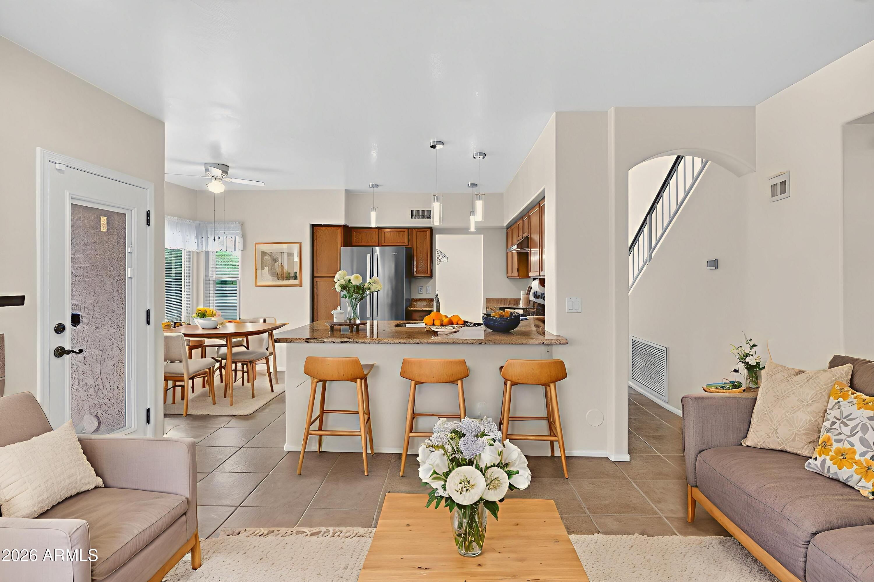 310 East Vaughn Avenue Gilbert, AZ 85234 - Photo 22 of 73 a living room with furniture kitchen view and a large window